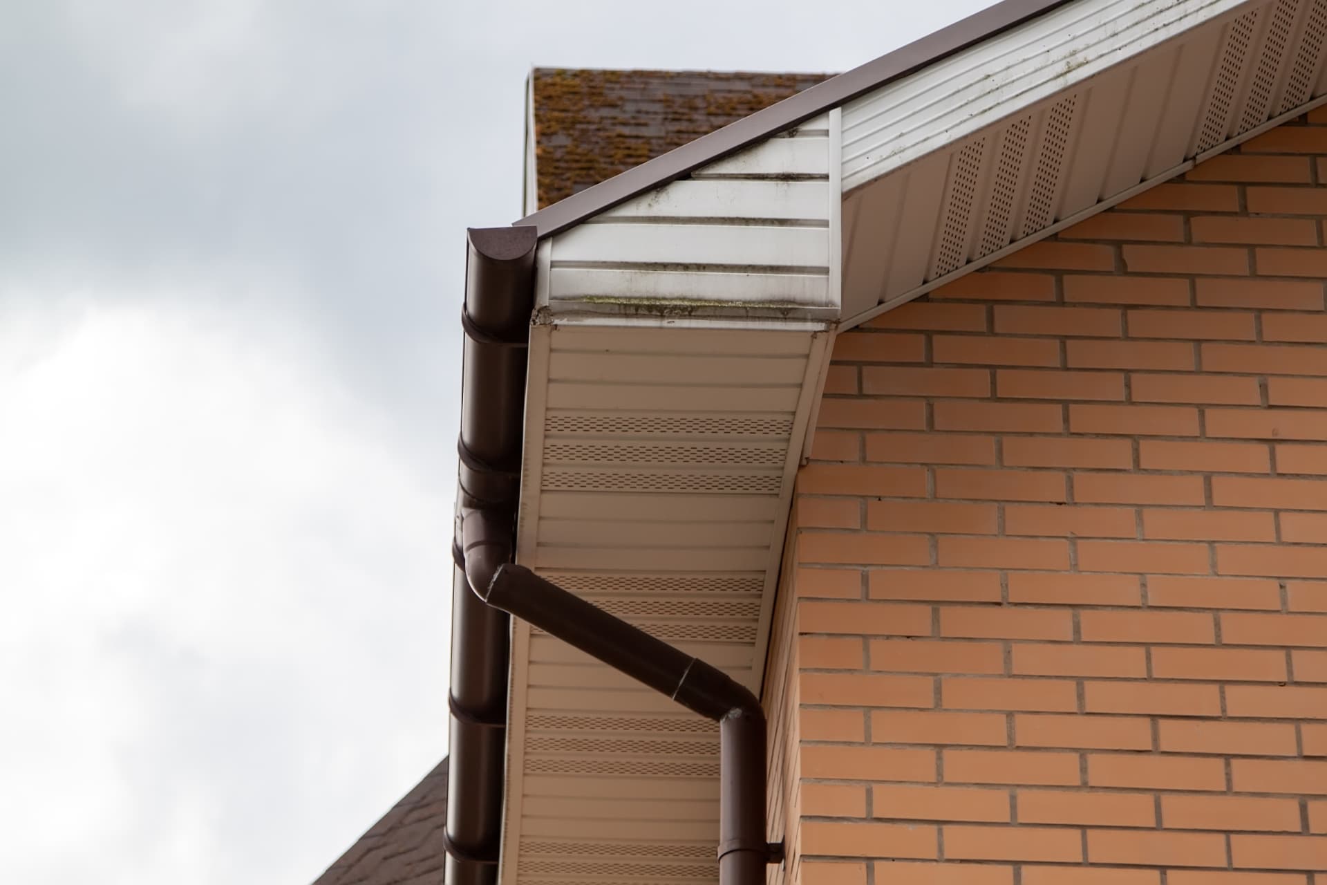 New UPVC fascia, vented soffit and downpipe on a brick house gable end