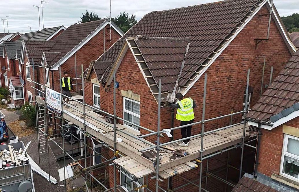 Scaffolded brick house during roofing work in Teesside