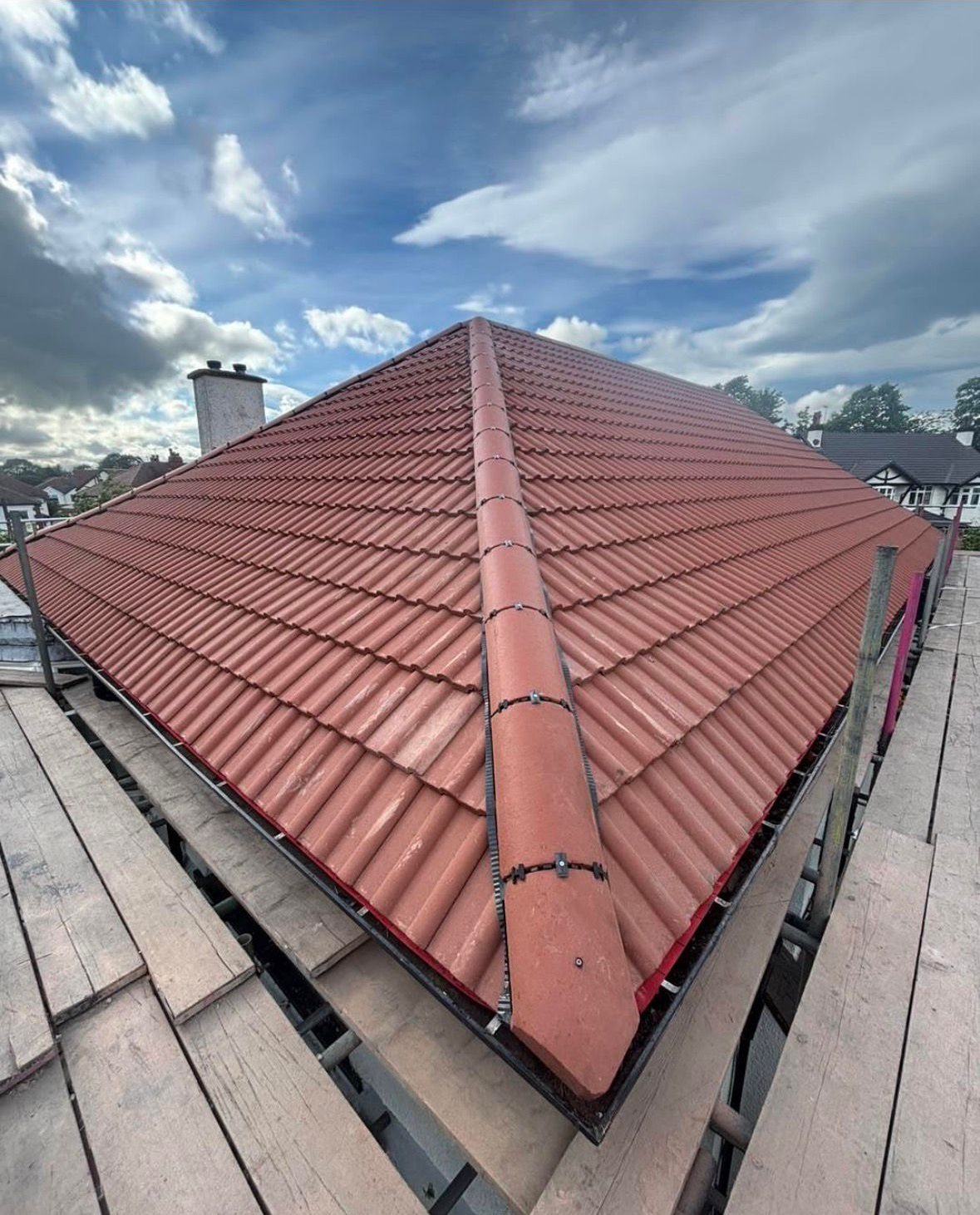 Newly finished red tiled roof with dry ridge and roofline trim on a Teesside home