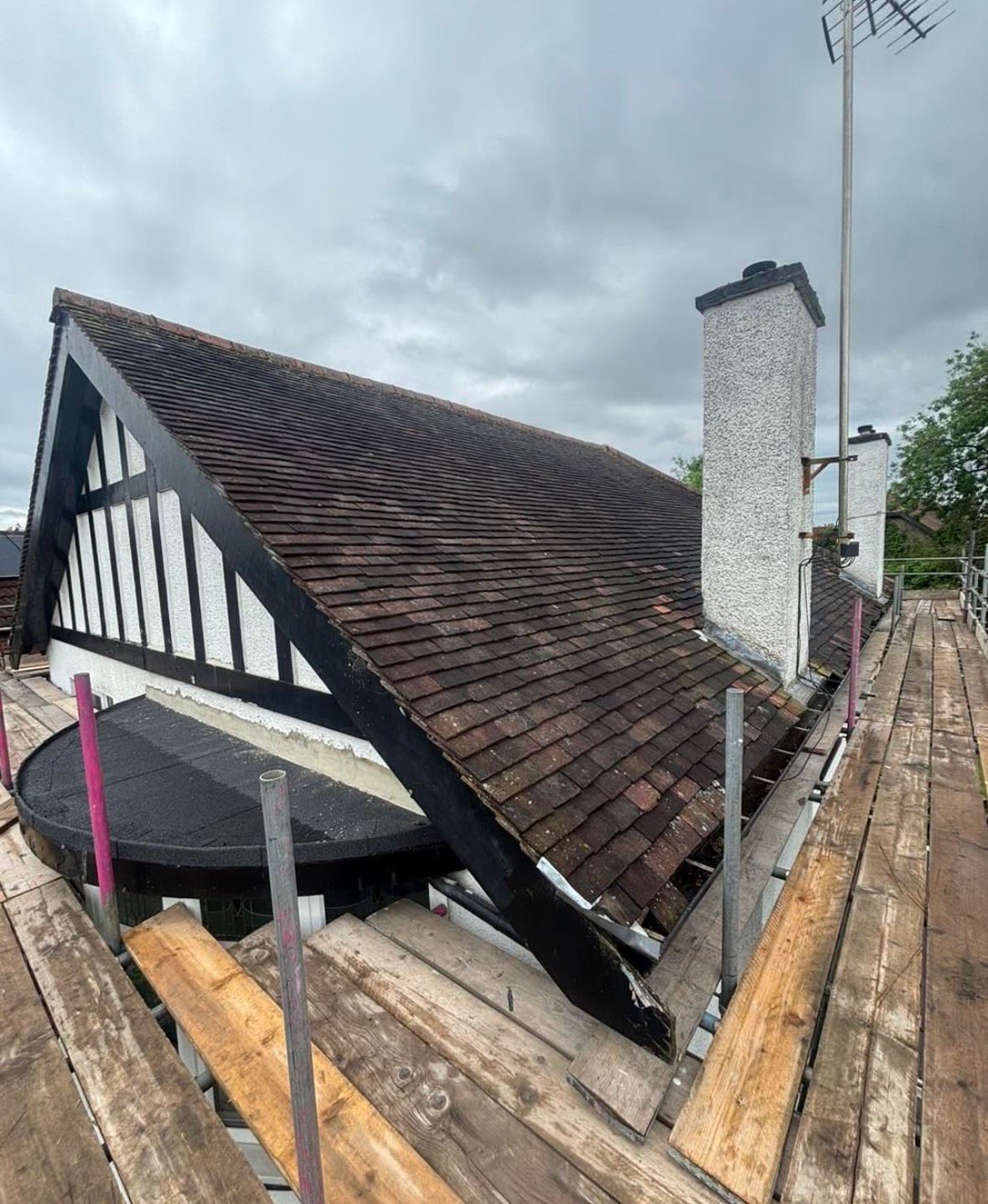 Old moss-covered clay tiled roof before stripping and re-roofing in Teesside