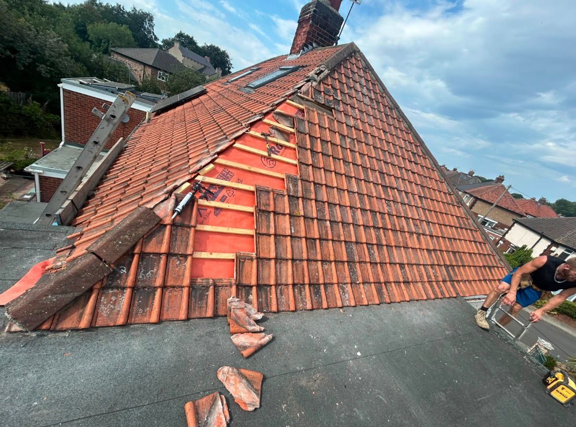 Section of tiled roof stripped back and re-covered with new membrane and battens during a roof repair in Teesside
